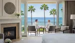Couple relaxing in their oceanview honeymoon suite on the California coast