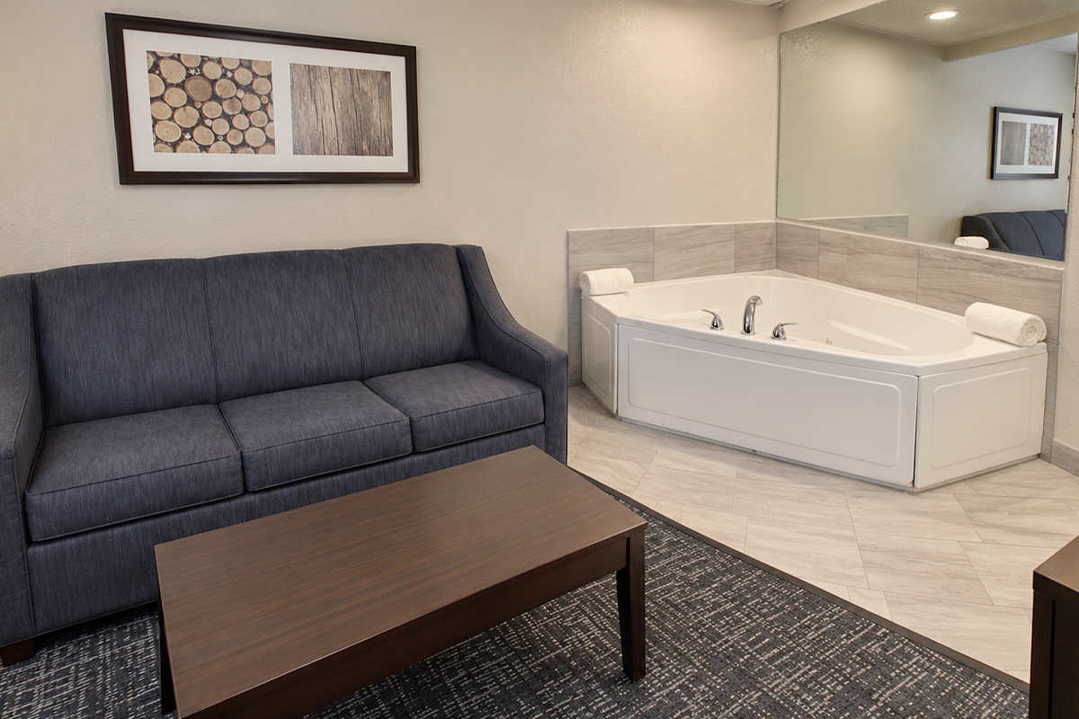 Spacious Suite with Corner Jetted Tub and Sofa at the Best Western Flint Airport Inn & Suites in Michigan.