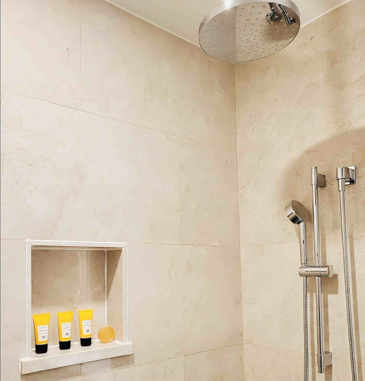 Walk-In Shower with a Rainfall Head in a Suite at the Blossom Hotel in Houston, TX