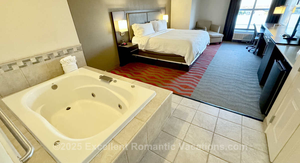 View inside the suite of a King Bed and an in-room jetted Whirlpool tub for 2 Persons at the Holiday Inn & Suites College Station-Aggieland, Texas