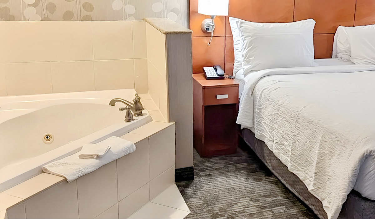 King Bed and Corner Whirlpool Tub in a Suite at Courtyard Toronto-Brampton, Ontario