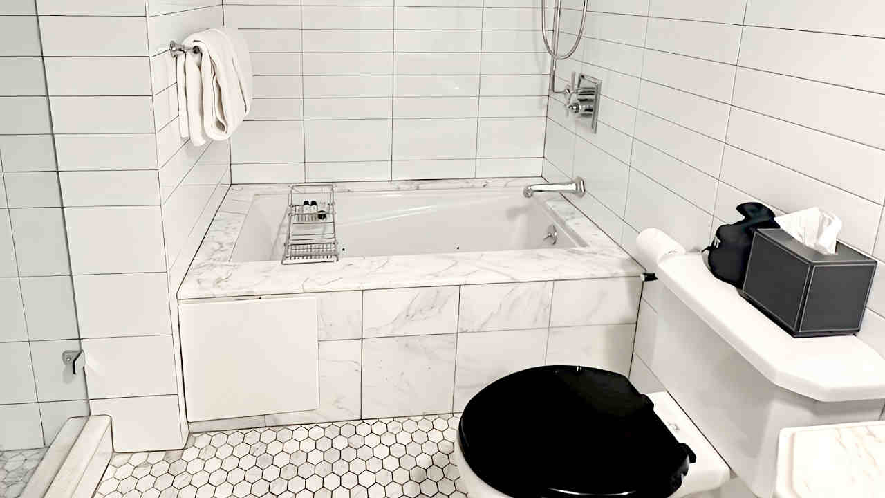 Evelyn Hotel Jetted Tub in a Porcelain Tile Master Bath.