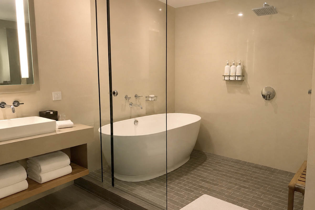 Walk-in shower with deep soaking tub in a suite at the Kimpton Hotel Palomar Phoenix.