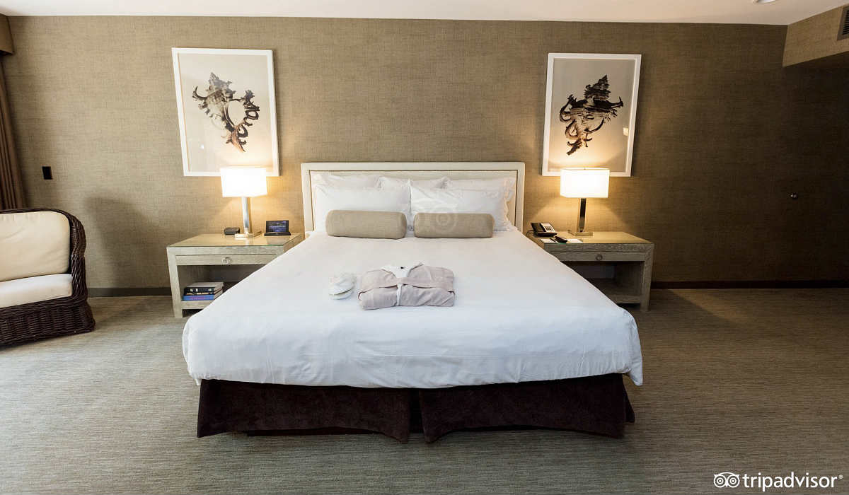 King Bed with Robes in a Suite at Luxe Sunset Boulevard Hotel in Los Angeles, CA