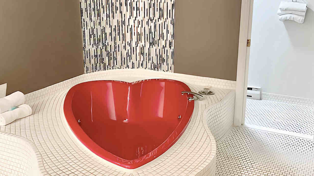 Red Heart-Shaped JACUZZI® Tub in a Budget Room at Kings Inn Near the Falls, Niagara Falls Ontario