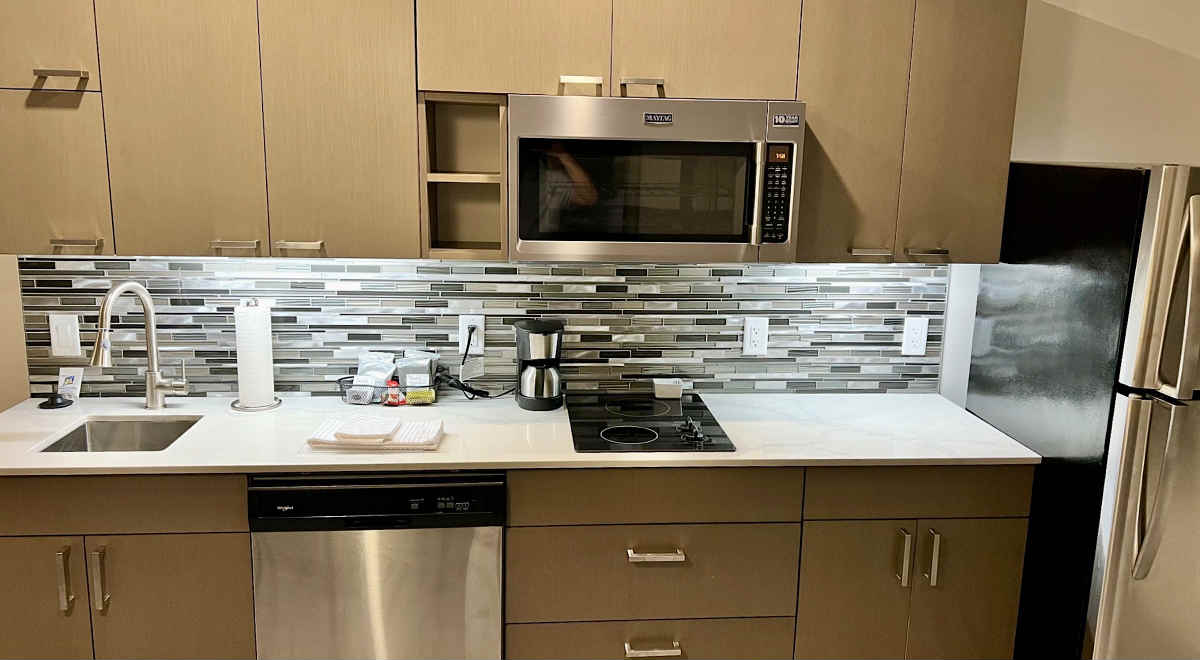 Kitchen with Microwave, Fridge, Dishwasher and Sink in a Suite at Hyatt House Winnipeg South.