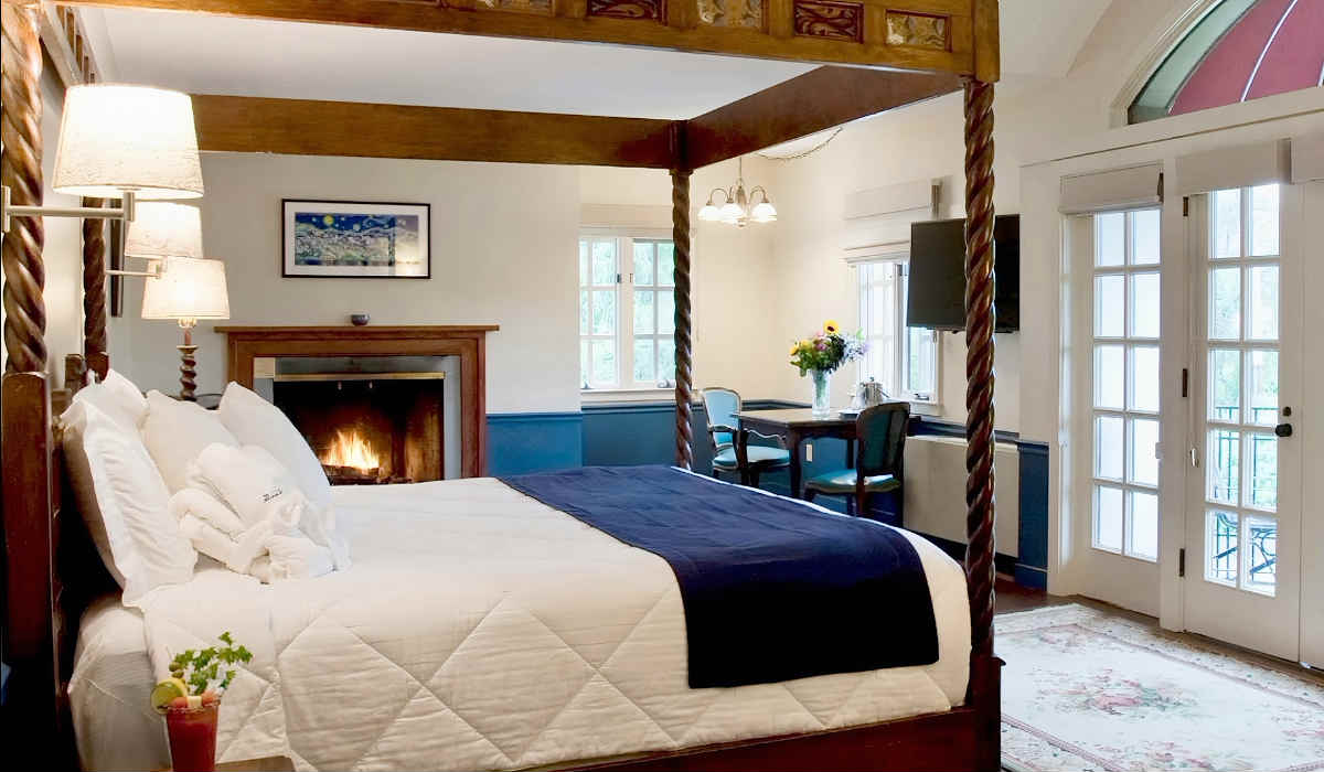 Romantic Room with Canopy Bed and Fireplace at La Tourelle Hotel & Spa in NY State.