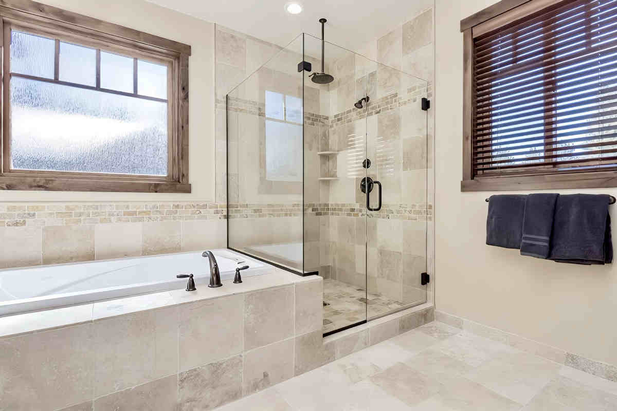 Photo of the Bathroom with soaker tub and walk-in rainfall shower in a luxury vacation rental in Mammoth Lakes, CA.