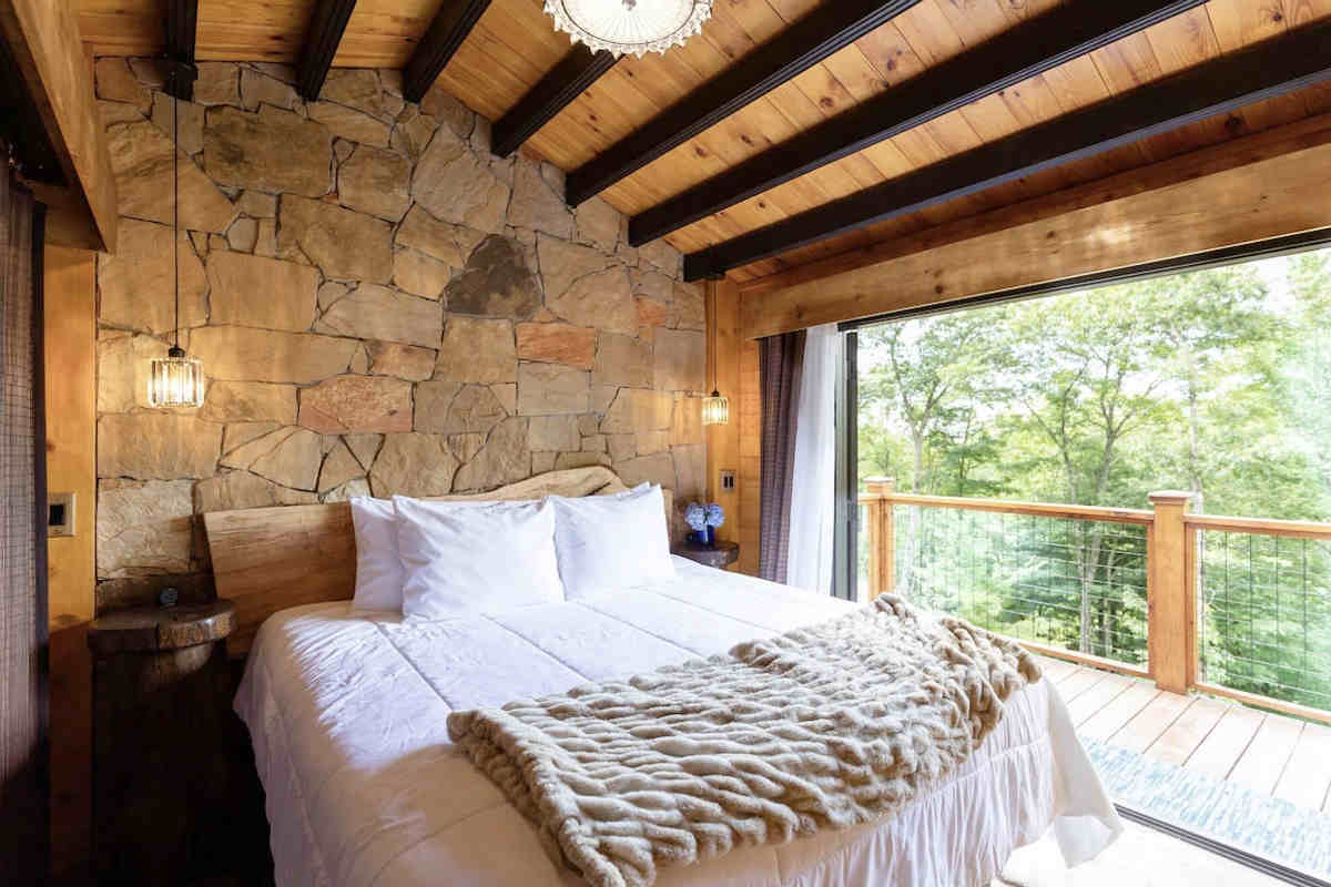 King Bed in a Honeymoon Log Cabin at Meraki Escape in North Carolina.