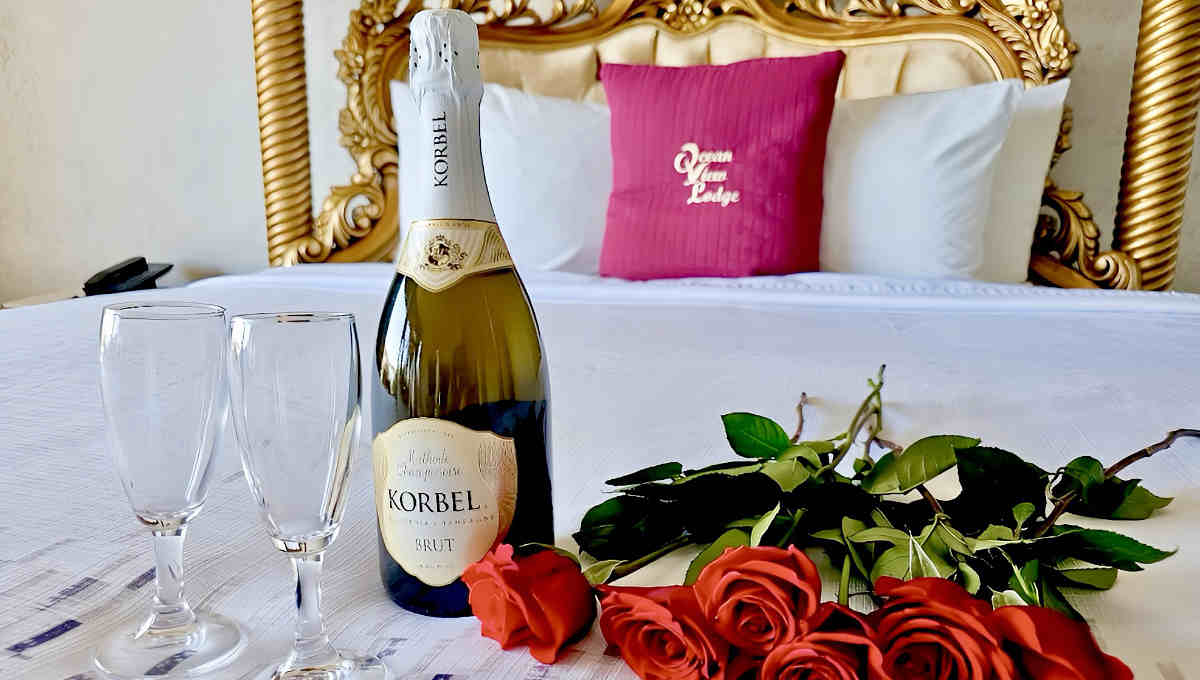Honeymoon Suite with Flowers and Wine on the King Bed at Ocean View Lodge in Fort Bragg, California