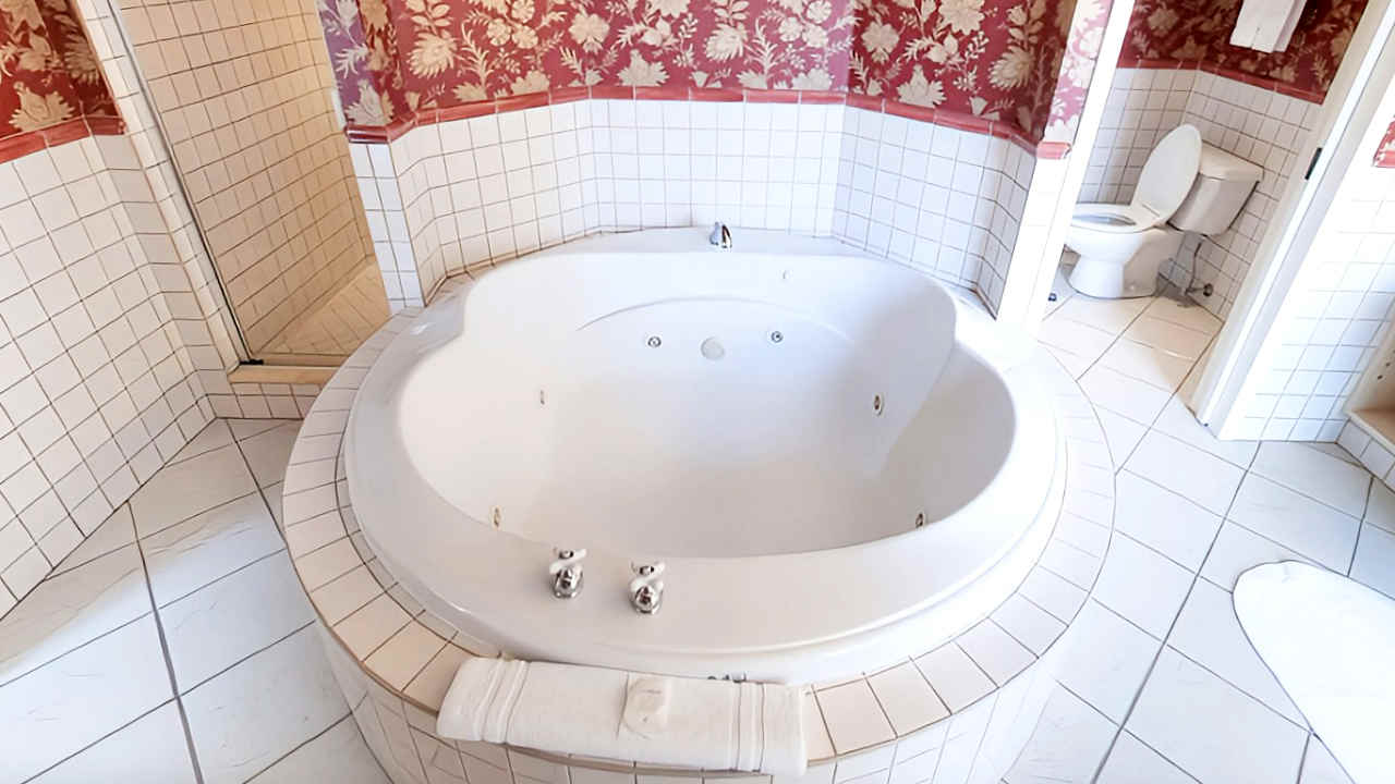Large 2-Person Whirlpool Tub in a Romantic Suite at Old Mill Hotel in Toronto, Ontario.
