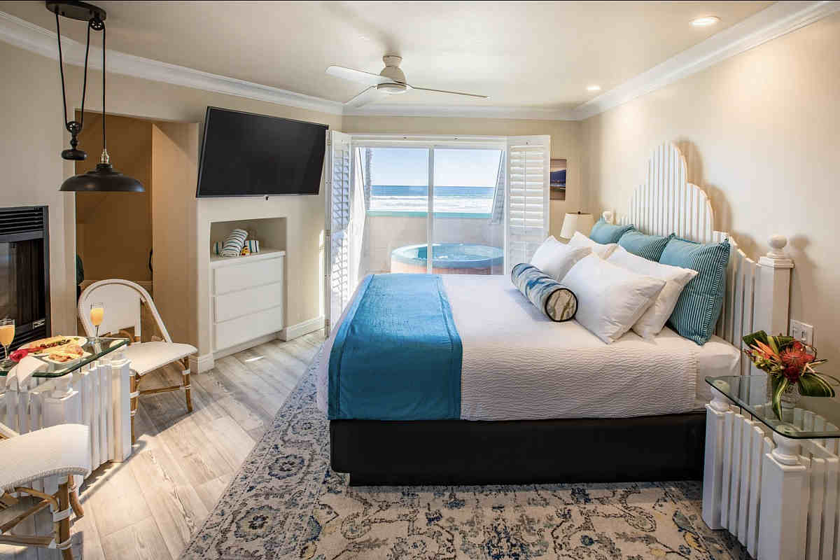 Romantic Honeymoon Suite with a King Bed, Fireplace and Private Outdoor Hot Tub for 2 at the SeaVenture Beach Hotel in Pismo Beach, CA.