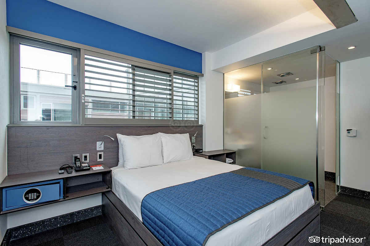 Queen Bed and Walk-In Shower at the Pod Hotel, Brooklyn NY