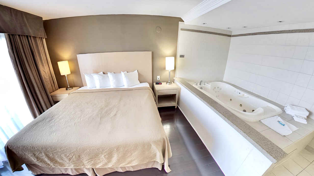 King Bed and Jetted Spa Tub at Quality Hotel Fallsview, Niagara Falls, ON