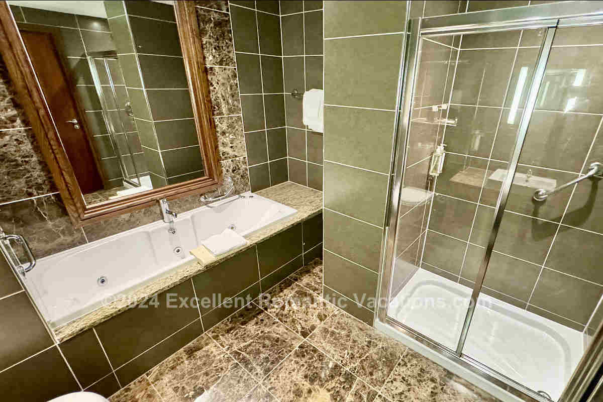 Spacious Marble Bathroom with Jetted Spa Tub and Walk-In Shower at Westport Plaza Hotel in Westport, County Mayo, Ireland