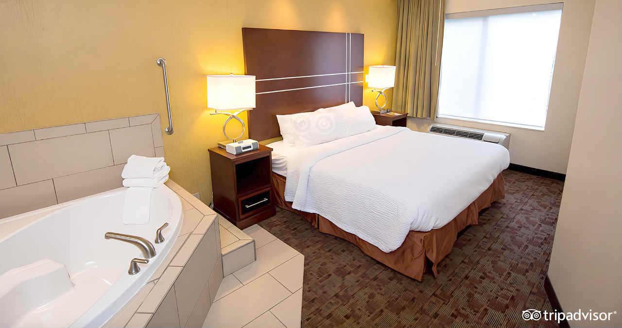 A Room with King Bed and a Corner Whirlpool Tub at Springhill Suites in Pigeon Forge, Tennessee
