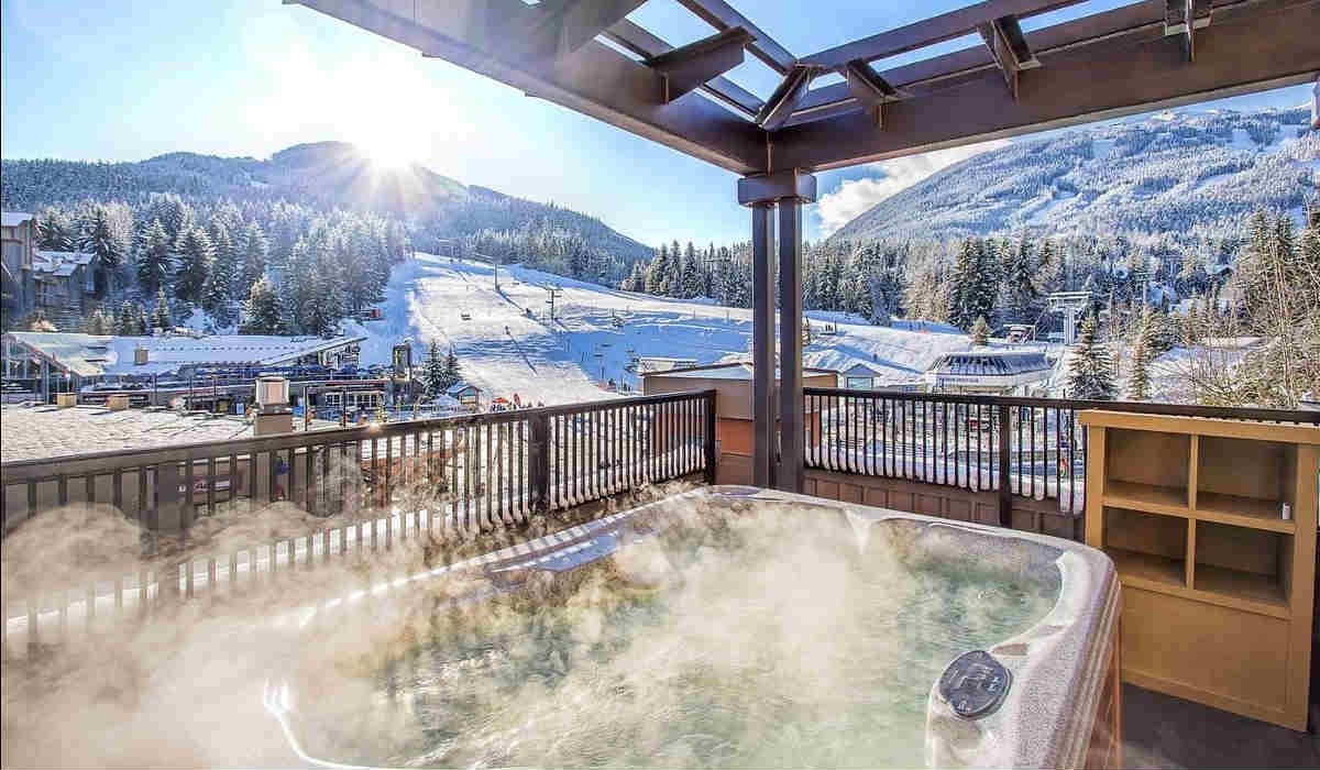 Honeymoon Suite with a Hot Tub for 2 People with a Mountain View on a Private Outdoor Patio at the Sundial Hotel in Whistler, BC Canada.