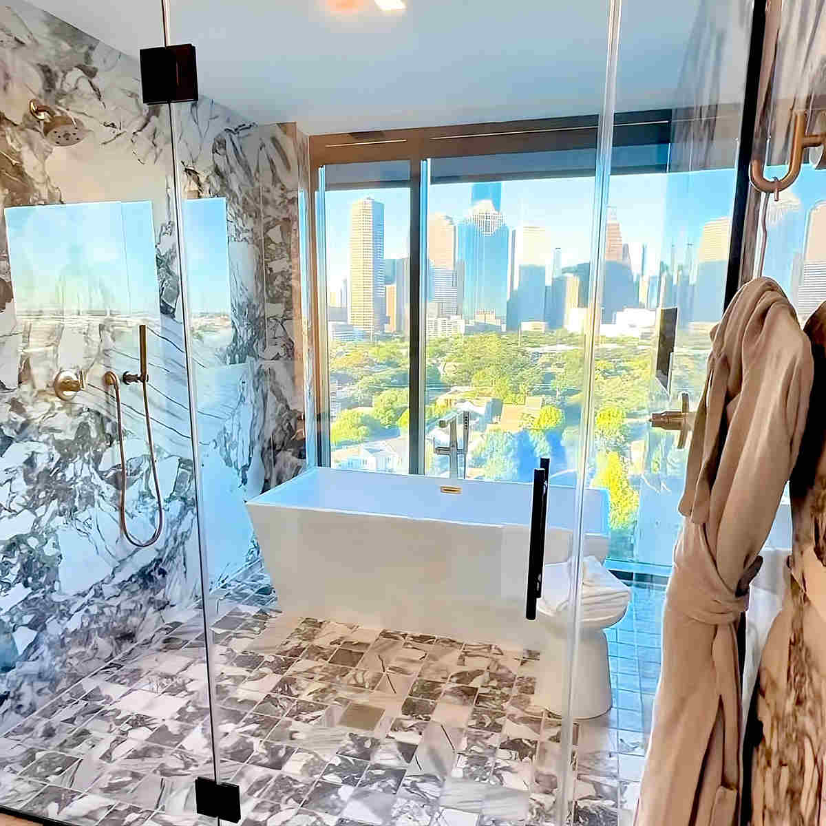 Beautiful Glass Walk-In Rain Shower with Soaker Tub and Amazing Views of Downtown Houston Texas.